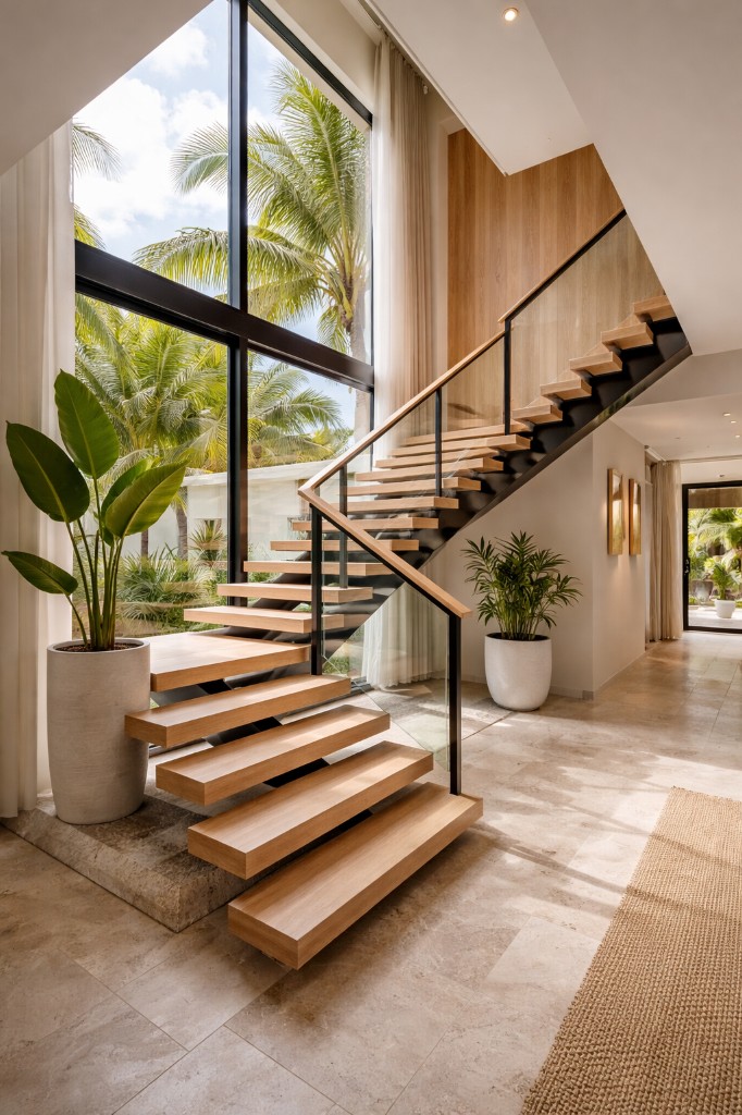 Symmetrical view of white villa with turquoise pool at dusk